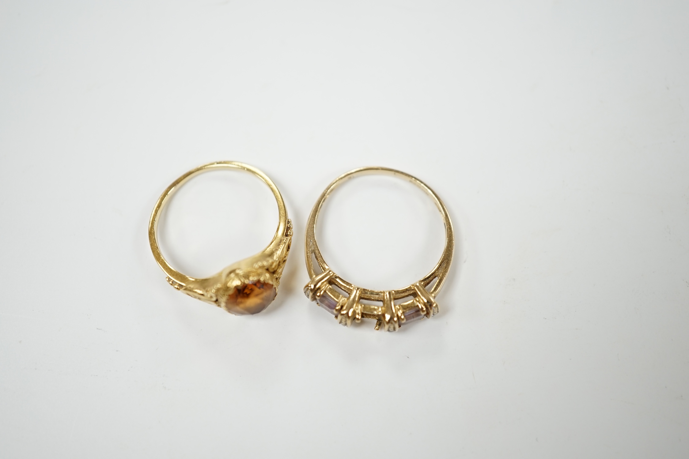 A 14k and single stone oval cut citrine set ring, size O, gross weight 2.8 grams and a modern 9ct gold and gem set ring (lacking stone), gross weight 2.3 grams. Condition - poor